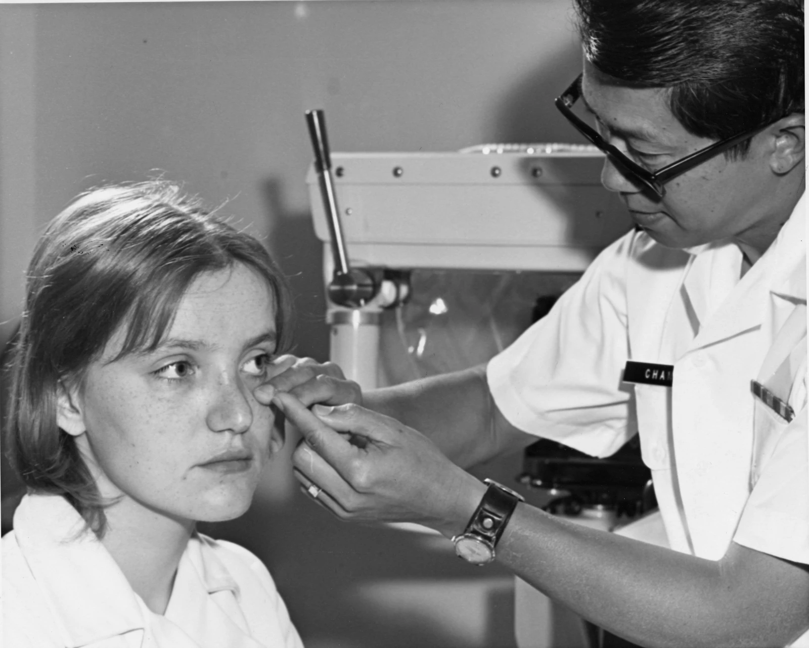 Doctor examines a woman's eye with equipment