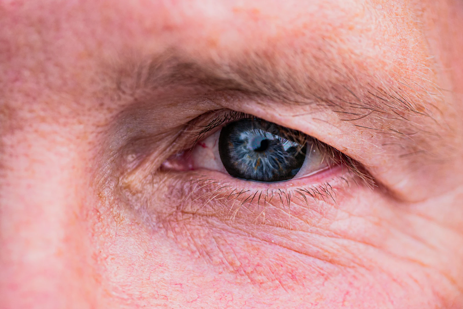 a close up of a man's blue eye