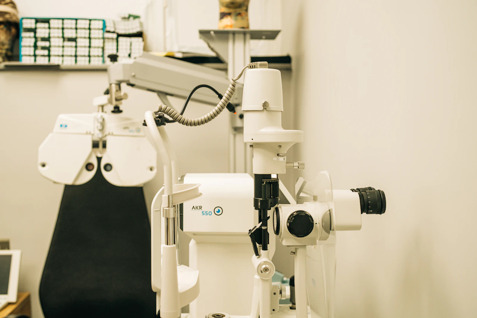 an eye exam room with a microscope and a monitor